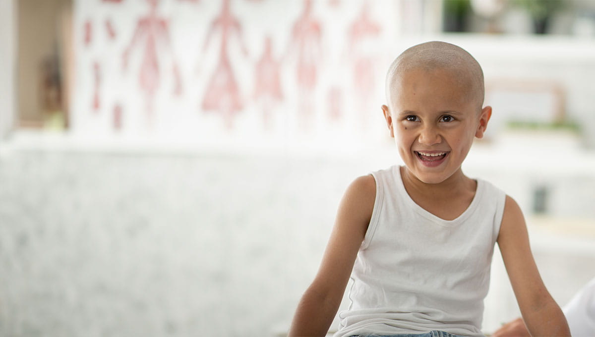 Photo of young cancer patient smiling.